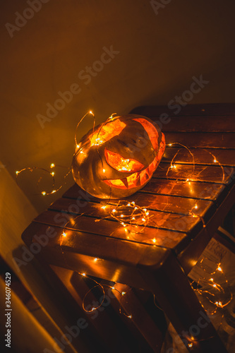 hand carved Halloween spooky pumpkin and sparkly lights