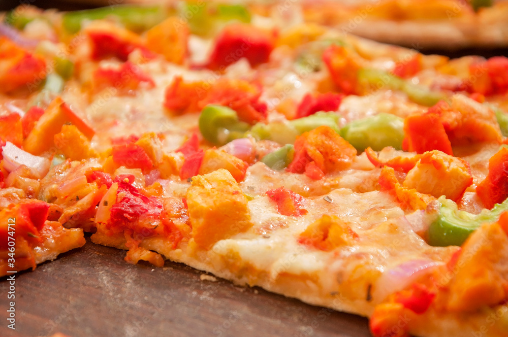 A chicken pizza served on a table ready to eat A chicken pizza served on a table ready to eat