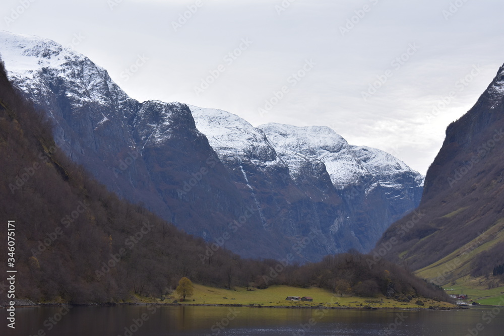 landscape of norway fjord with snow  and cloudy sky in winter.mountain ranges with snow at peak
