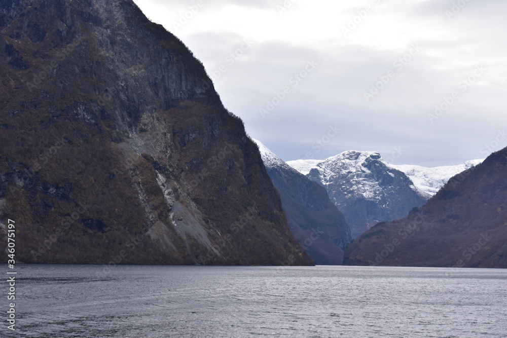 landscape of norway fjord with snow  and cloudy sky in winter.mountain ranges with snow at peak