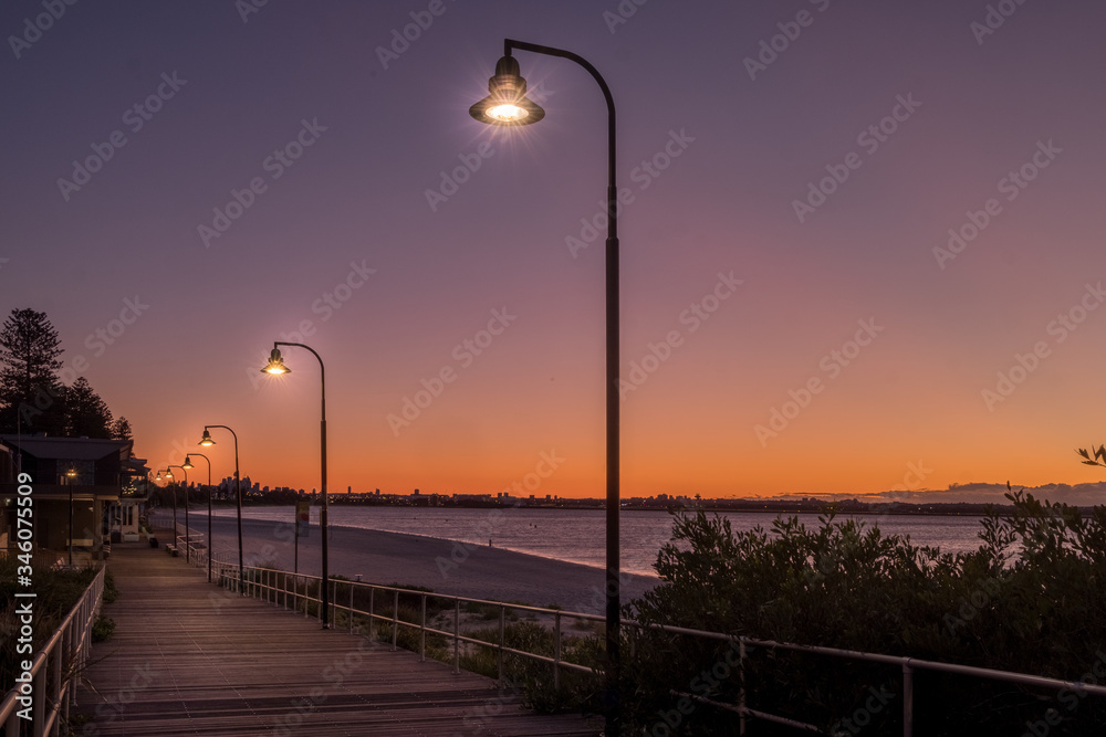 lamp posts on a boardwalk at dawn