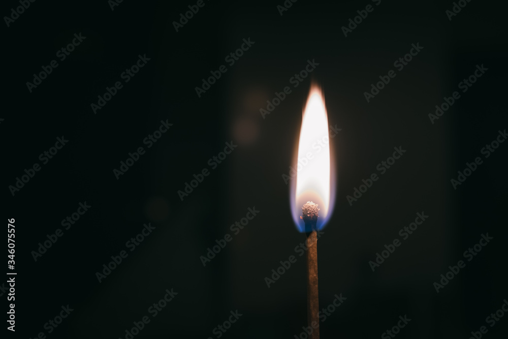 Burning match flame close up still on a black background Burning match flame close up still on a black background