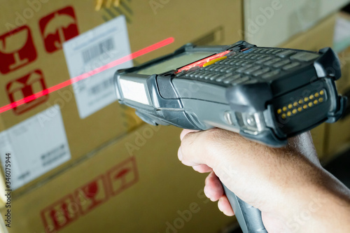 Workers Scanning Bar Code Scanner on Package Boxes. Shipping Warehouse. Computer Mobile Work Tools for Inventory Management. Shipping Storehouse.