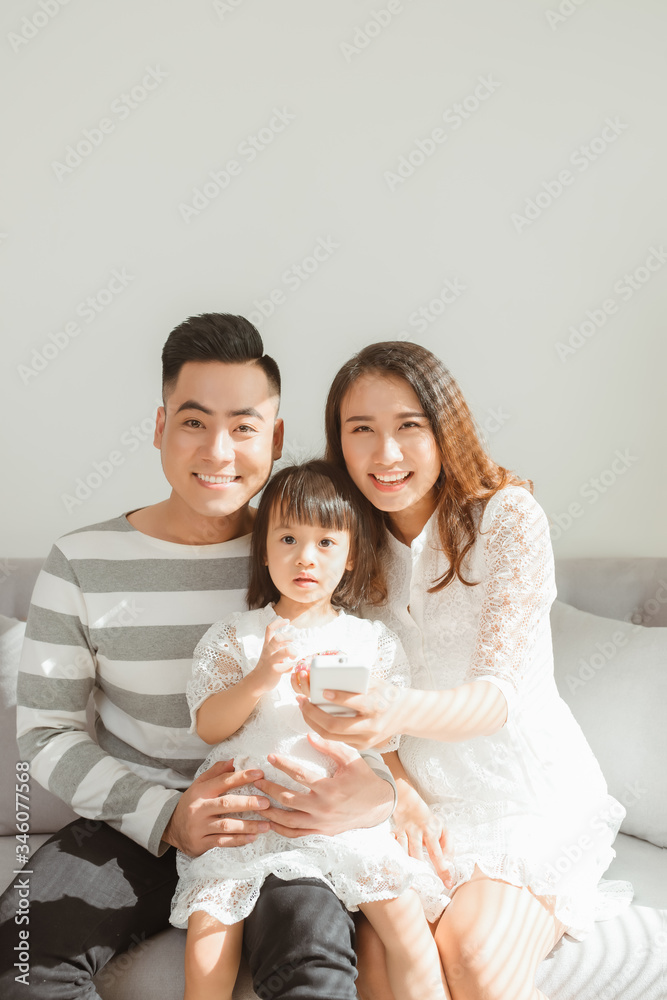Happy family with children using mobile apps together at home Happy family with children using mobile apps together at home