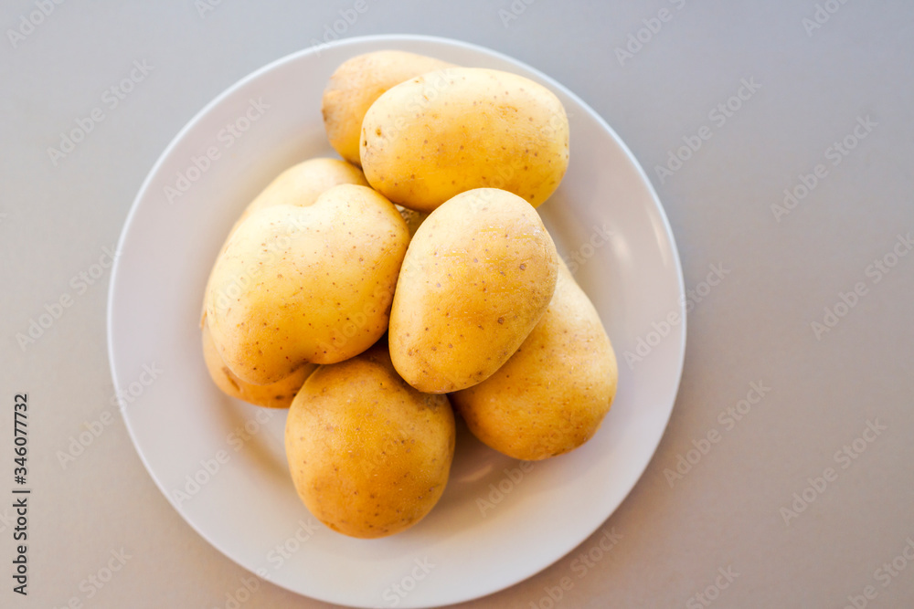 close up potatoes on kitchen table close up potatoes on kitchen table