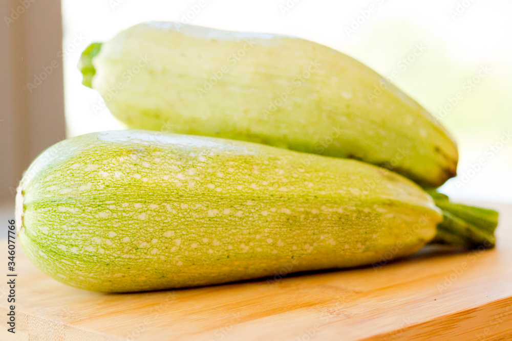 Fresh zucchini on wooden background