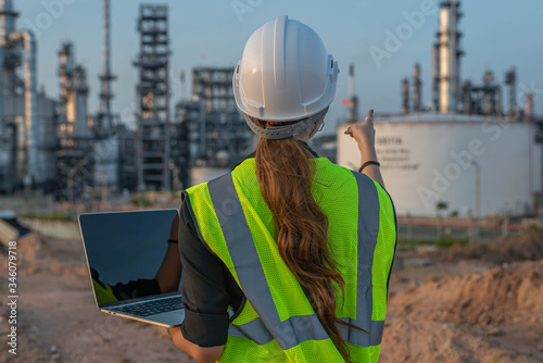 White woman engineer, logistics and transportation business of gas and oil with background of oil and gas refinery, import, export and transportation in the industry