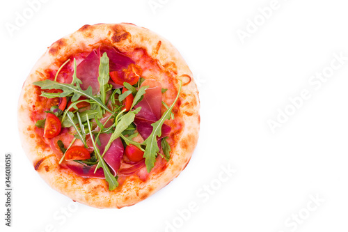 Pizza with ham, tomatoes, arugula and mushrooms on a white background.