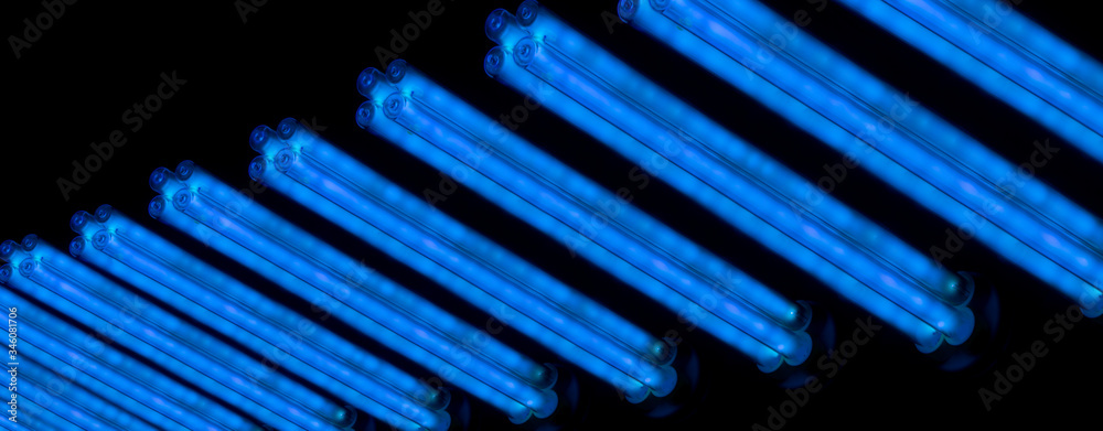 A lot of ultraviolet lamps turned on in the dark. UV-C ray. germicidal lamps. A lot of ultraviolet lamps turned on in the dark. UV-C ray. germicidal lamps.