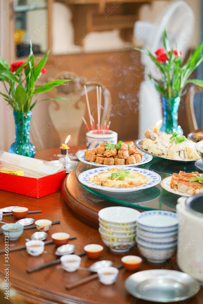 Food offering to Chinese ancentors during the Chinese spring festival or Chinese New Year with soft focus on the deep fried crab meat roll.