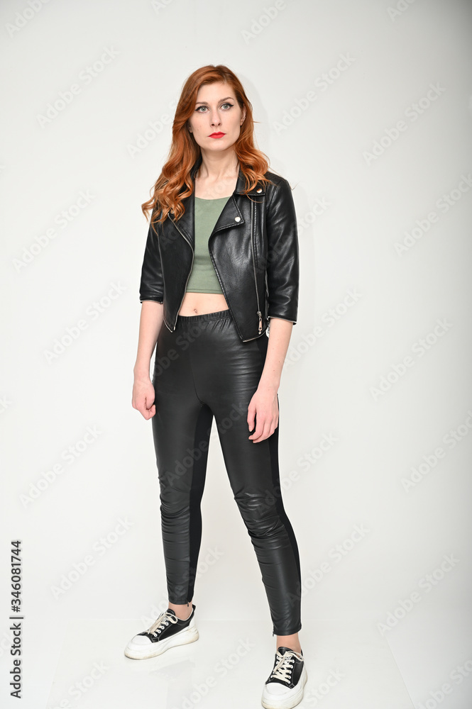Portrait of a young pretty girl with beautiful hair in a green T-shirt and black clothes on a white background. Woman shows emotions changing poses. Portrait of a young pretty girl with beautiful hair in a green T-shirt and black clothes on a white background. Woman shows emotions changing poses.