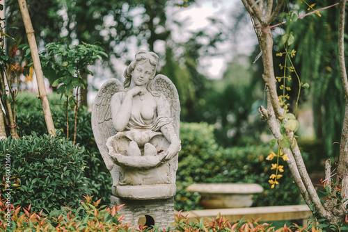Angel statue. A classical Roman style of lady angel with wings decoration in the public garden.