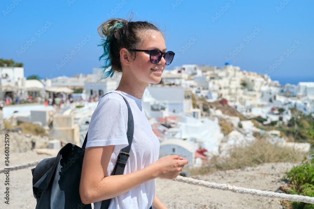 Teenager girl resting on Greek island Santorini, looking away