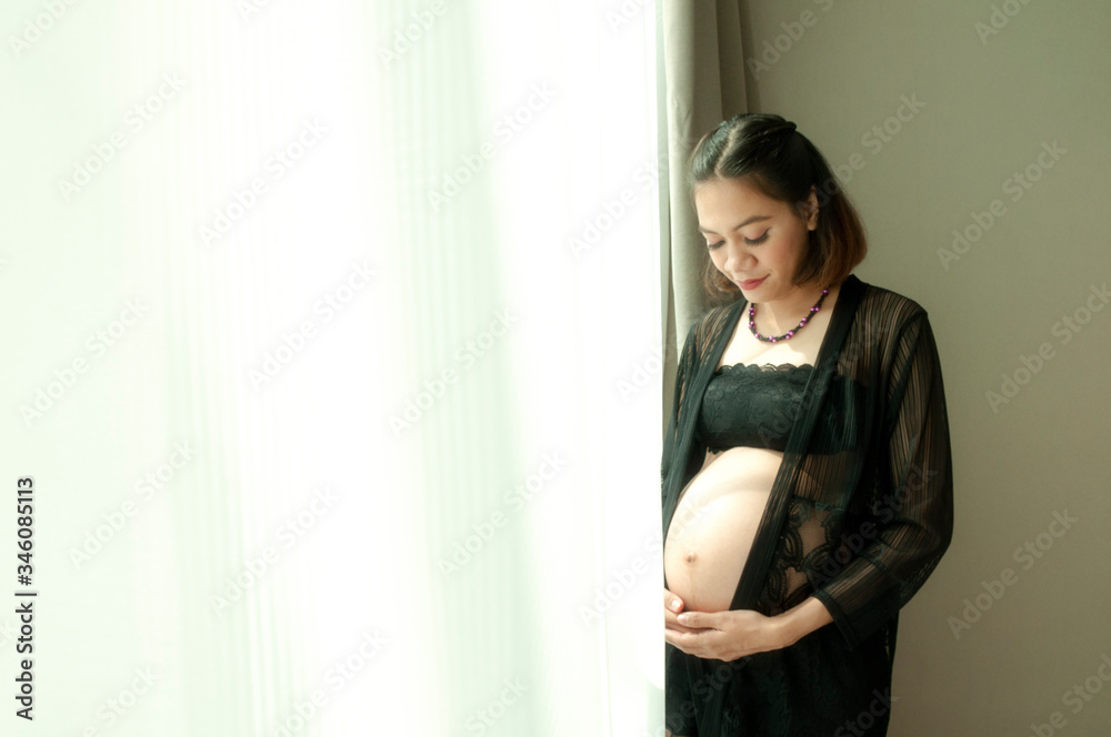 Portrait shoot of young beautiful pregnantsoutheast asia woman posing for maternity photoshoot lifestyle, pregnant stomach. Stylish happy mother to be waiting for a miracle Portrait shoot of young beautiful pregnantsoutheast asia woman posing for maternity photoshoot lifestyle, pregnant stomach. Stylish happy mother to be waiting for a miracle