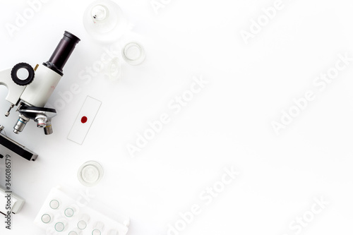 Research with microscope. Laboratory backround with blood sample on white table top view copy space