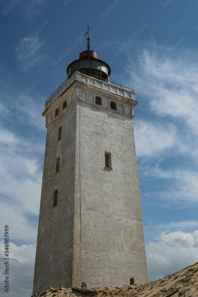 LIghthouse with blue sky and clouds råbjerg knude in skagen denmark