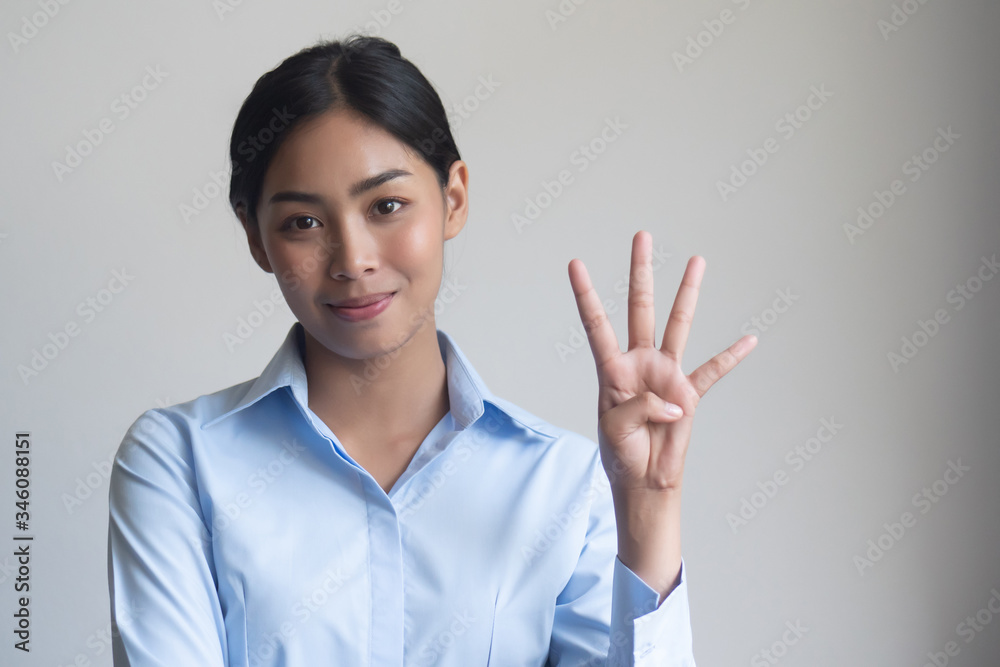 asian office woman pointing, counting four finger; portrait of positive happy smiling asian woman pointing up 4 fingers for number four or 4 points concept ; southeast asian adult woman model asian office woman pointing, counting four finger; portrait of positive happy smiling asian woman pointing up 4 fingers for number four or 4 points concept ; southeast asian adult woman model
