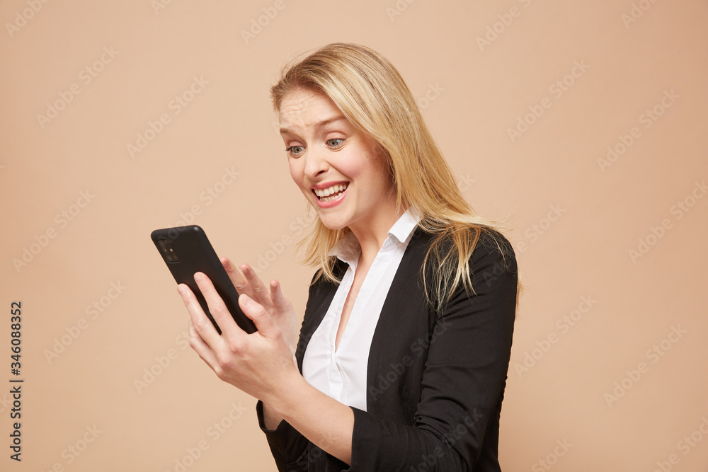 Beautiful, surprised businesswoman with a cellphone Beautiful, surprised businesswoman with a cellphone