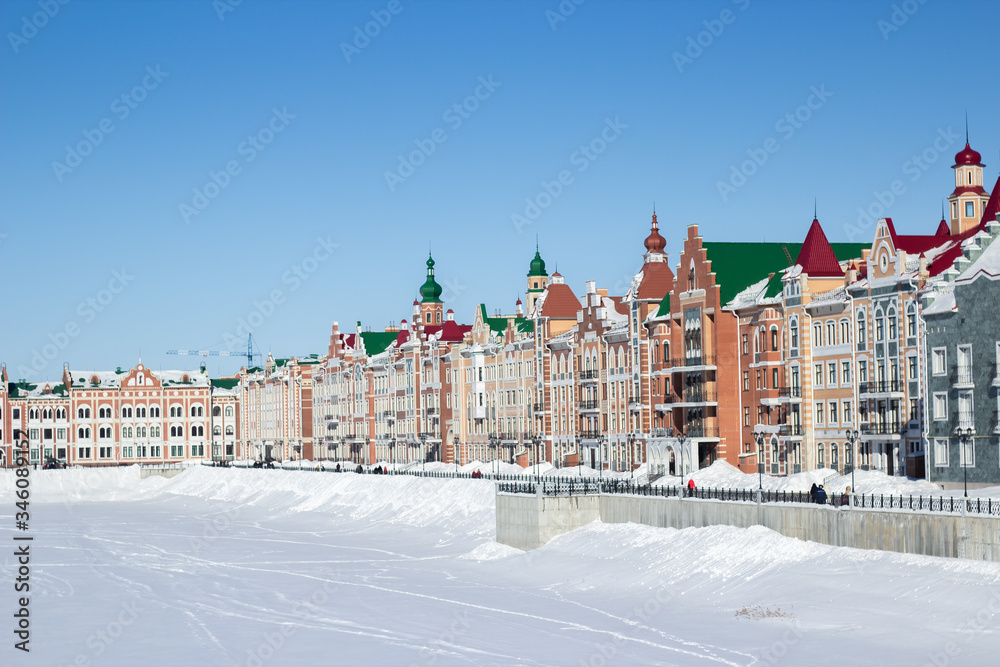 Waterfront houses in the city of Yoshkar-Ola, in Russia. Winter snow. Sights of the city of Yoshkar-Ola. Colorful houses.