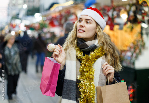 Woman holding bags with Christmas toys