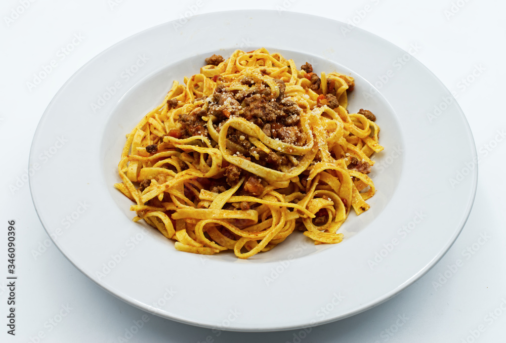 
Fettuccine with ragu bolognese and parmesan isolated on white. Italian pasta
