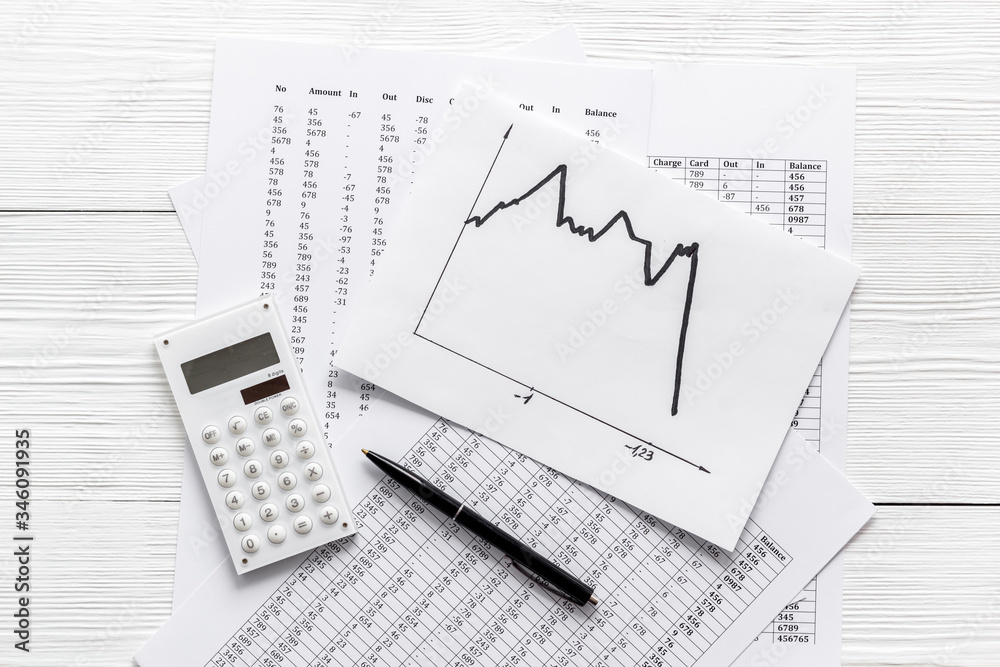 Financail crisis - business grahp, markets crash - on white wooden background top-down Financail crisis - business grahp, markets crash - on white wooden background top-down