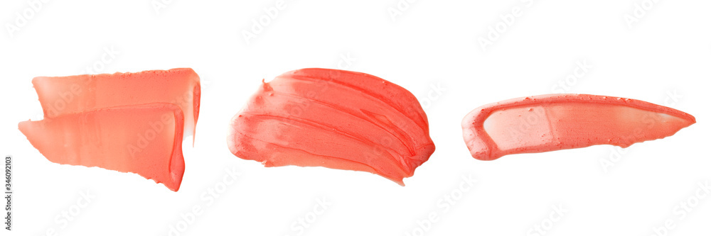 Texture and stroke of red lip gloss on a white background.