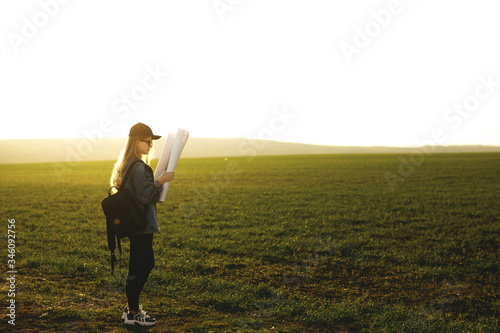 Portrait of a traveler girl looking direction on world map. Freedom and active lifestyle concept, adventure, trip.