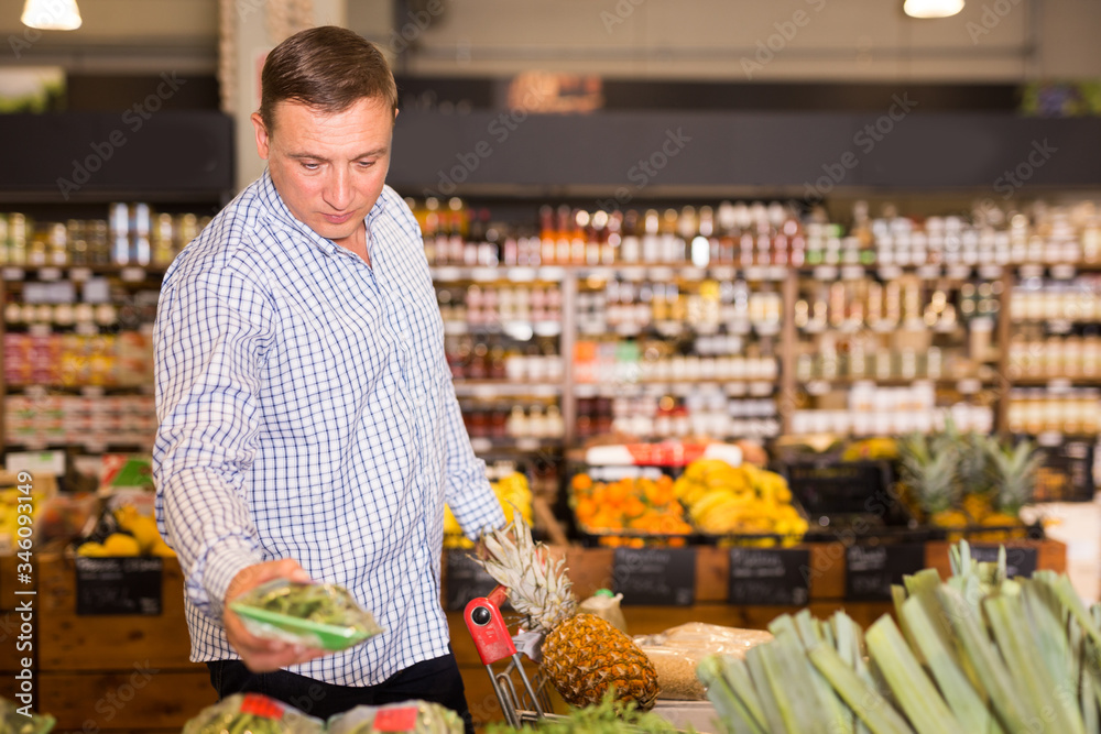 Man buying greens for salad
