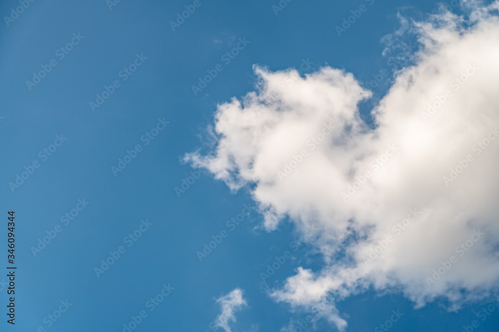 A low angle shot of a beautiful cloudscape on a blue sky background A low angle shot of a beautiful cloudscape on a blue sky background