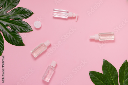 Face skin care cosmetic set flat lay on pick tropical background. Skin care gel top horizontal view copyspace