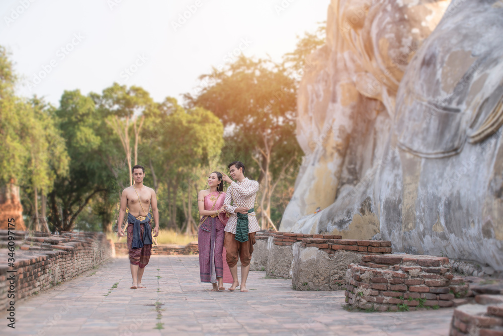 Young Asian people are wearing the Thai dress visit temples. Culture concept.