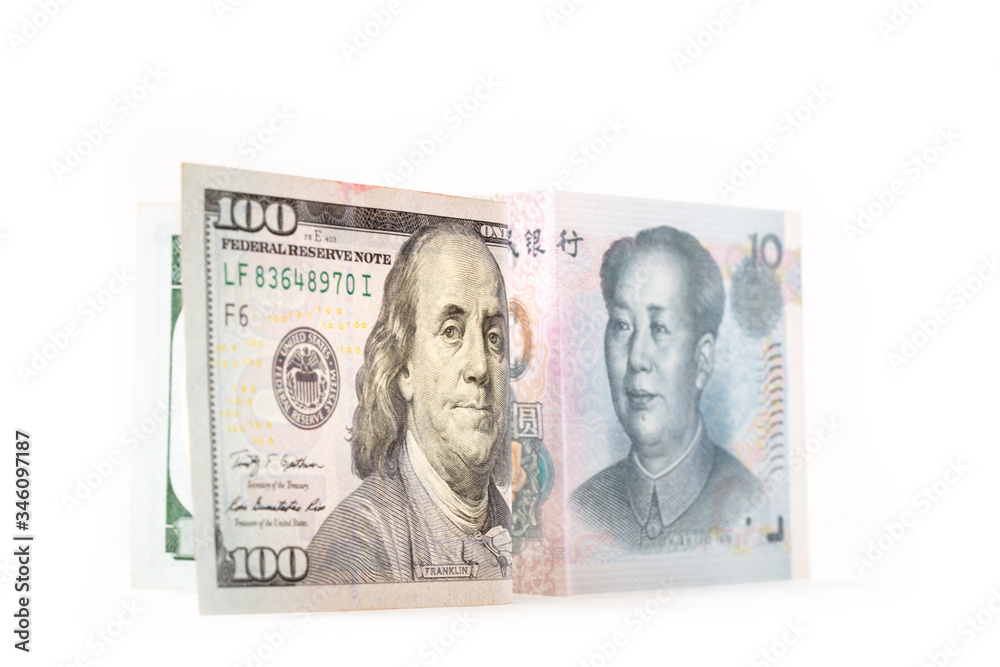Chinese Yuan Note and united states of america U.S. dollar on white background, Trade wars and relationship between the two countries concept, selective focus on U.S. dollar Note Chinese Yuan Note and united states of america U.S. dollar on white background, Trade wars and relationship between the two countries concept, selective focus on U.S. dollar Note