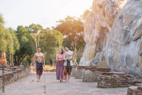 Young Asian people are wearing the Thai dress visit temples. Culture concept.