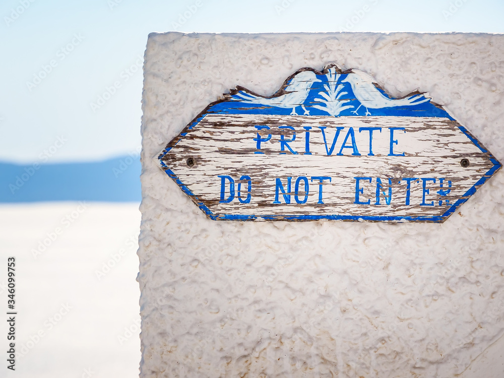 Fototapeta premium Wooden sign with lettering dont enter, private. Santorini, Cyclades, Greece.
