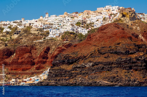 Amazing Santorini view on white cave houses from the Aegean sea. Cyclades, Greece. .
