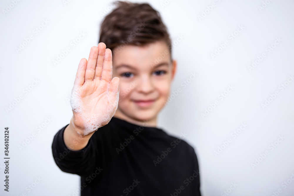 Front view on boys hand with soap foam and text wash your hands, focus on hand, personal hygiene concept. Coronavirus , Covid-19 prevention Front view on boys hand with soap foam and text wash your hands, focus on hand, personal hygiene concept. Coronavirus , Covid-19 prevention