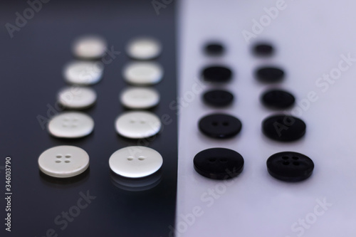 A group of clothing buttons lined up in rows and placed on top of each other to create a contrast © Yaikel Dorta