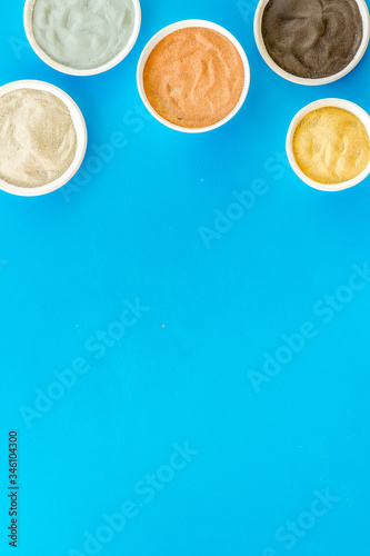 Yellow, red, white, blue and black cosmetic clay top view copy space