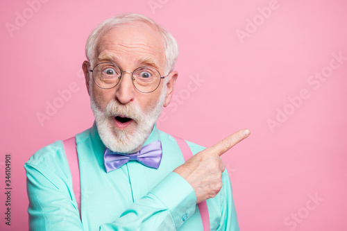 Closeup photo of cool aged man open mouth indicate fingers empty space black friday prices wear specs mint shirt suspenders bow tie isolated bright pink pastel color background photo
