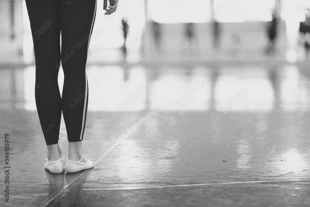 A woman with slim legs is standing in the rehearsal room A woman with slim legs is standing in the rehearsal room