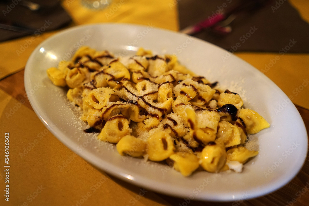 Close up Tortellini- ring-shaped pasta made from durum wheat, eggs, and stuffed with meat, cheese or vegetable Close up Tortellini- ring-shaped pasta made from durum wheat, eggs, and stuffed with meat, cheese or vegetable