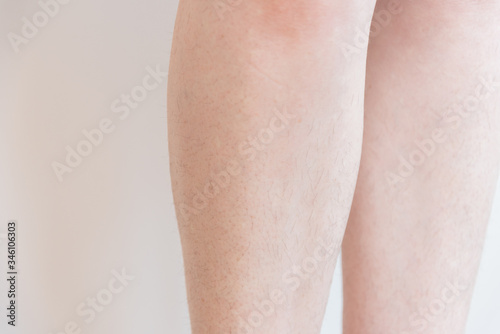 Female legs covered with hair. The legs were overgrown during the period of self-isolation. Humor and body positivity. Coronavirus.