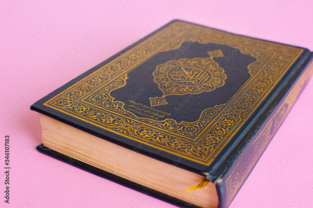 Quran on a light pink background. Space fot text. Ramadan kareem. Quran on a light pink background. Space fot text. Ramadan kareem.