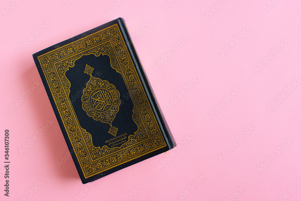 Quran on a light pink background. Space fot text. Ramadan kareem. Quran on a light pink background. Space fot text. Ramadan kareem.