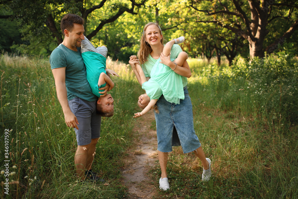 Fototapeta premium Happy loving family with two children, son and daughter playing and hugging. Family walk. Happy Mothers day.