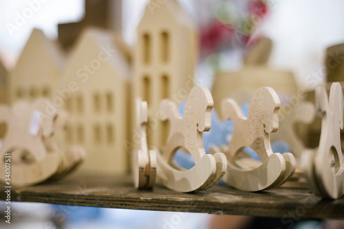 Little decorative wooden horses and houses closeup