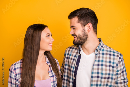 Closeup photo pretty lady handsome guy toothy smiling tenderness look eyes with love emotions hugging stand close wear casual plaid shirts isolated yellow color background © deagreez