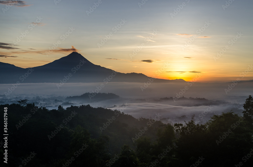 smoking volcano at sunset in yogyakarta java indonesia