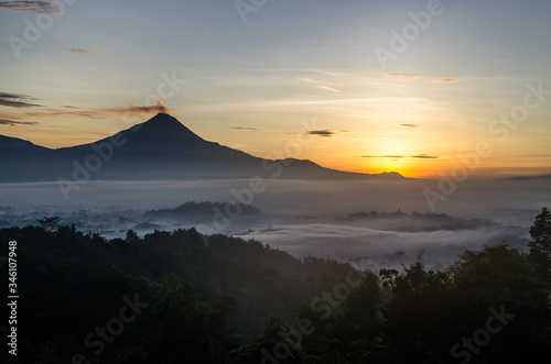 smoking volcano at sunset in yogyakarta java indonesia